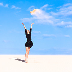 Image showing Playful girl throwing sand in the air.