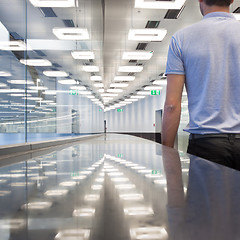 Image showing Business travelers in airport terminal hall.