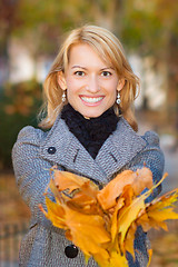 Image showing Lady with autumn leaves.