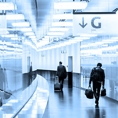 Image showing Business travelers in airport terminal hall.