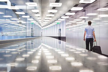 Image showing Business travelers in airport terminal hall.