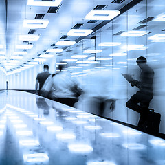 Image showing Business travelers in airport terminal hall.