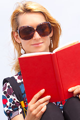 Image showing Attractive young lady reading a book.