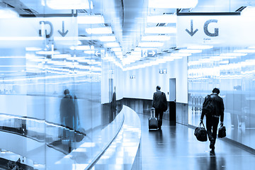 Image showing Business travelers in airport terminal hall.