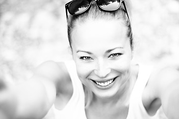 Image showing Black and white portrait of a cheerful young woman.