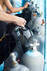 Image showing Guy checking the diving equipment.