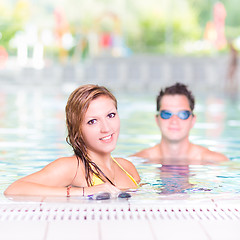 Image showing Young couple in the swimming pool.