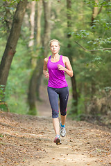 Image showing Pretty young girl runner in the forest. 