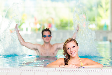 Image showing Young couple in the swimming pool.