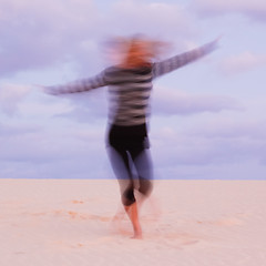 Image showing Girl swirling at the sand dune.