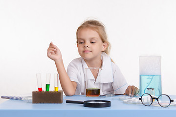 Image showing Chemist selects reagent in a test tube