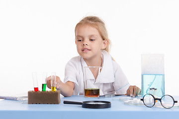 Image showing Chemist indicates the tube with reagent