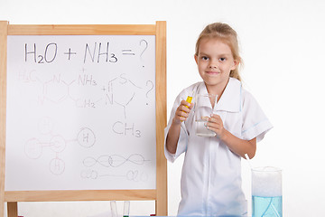 Image showing Girl the reagents at blackboard with a formula