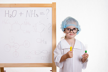 Image showing Chemist in points and with two tubes at board