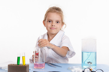 Image showing Schoolgirl conducts experiments in chemistry class