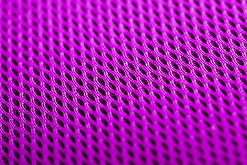 Image showing magenta background. Mesh fabric texture. Macro