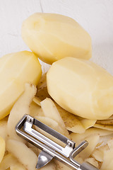 Image showing Potatoes with Peeler and Peeled Skin