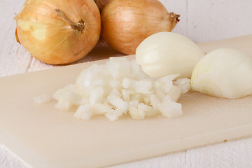 Image showing Whole, peeled and diced brown onion