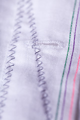 Image showing Closeup Small Buttons on White Cloth