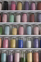 Image showing Shelving with glass jars of colorful pigments