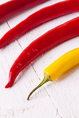 Image showing Fresh red and yellow chili peppers with spice