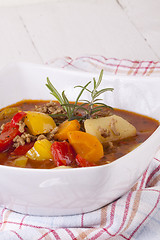 Image showing Hearty Stew in Bowl and Spoon on Plaid Dish Towel