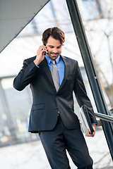 Image showing Businessman listening to a call on his mobile