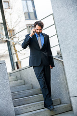 Image showing Businessman listening to a call on his mobile