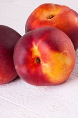 Image showing Three tasty fresh ripe juicy nectarines