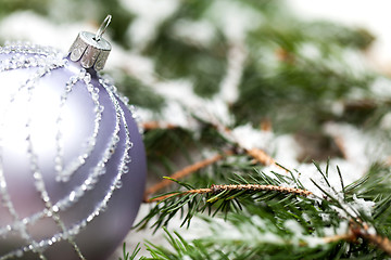 Image showing Silver Christmas ornaments in leaves