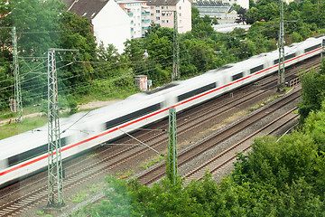 Image showing Fast moving train with red stripe