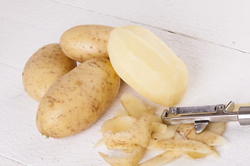 Image showing Potatoes with Peeler and Peeled Skin