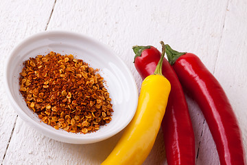 Image showing Fresh red and yellow chili peppers with spice