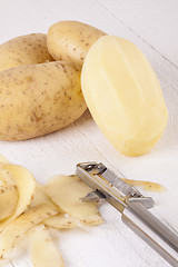 Image showing Potatoes with Peeler and Peeled Skin