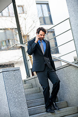 Image showing Businessman listening to a call on his mobile