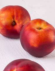 Image showing Three tasty fresh ripe juicy nectarines