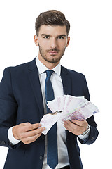 Image showing Wealthy successful businessman burning money