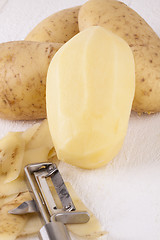 Image showing Potatoes with Peeler and Peeled Skin