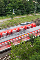 Image showing Fast moving train with red stripe