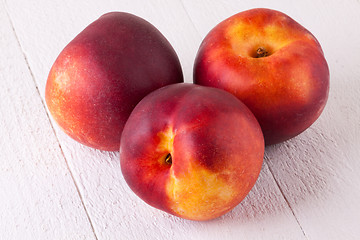 Image showing Three tasty fresh ripe juicy nectarines