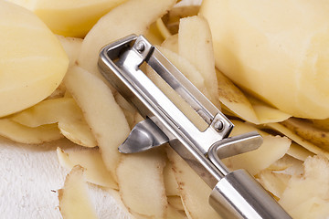 Image showing Potatoes with Peeler and Peeled Skin