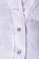 Image showing Closeup Small Buttons on White Cloth