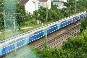 Image showing Fast moving train with red stripe