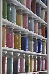 Image showing Shelving with glass jars of colorful pigments