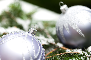 Image showing Silver Christmas ornaments in leaves