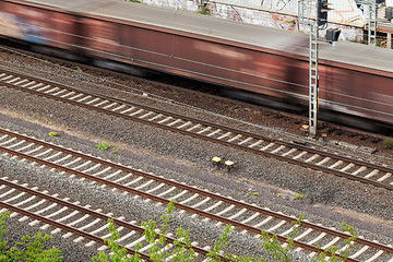 Image showing Fast moving train with red stripe