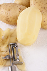 Image showing Potatoes with Peeler and Peeled Skin