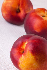 Image showing Three tasty fresh ripe juicy nectarines