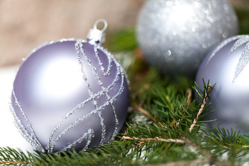 Image showing Silver Christmas ornaments in leaves