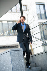 Image showing Businessman listening to a call on his mobile